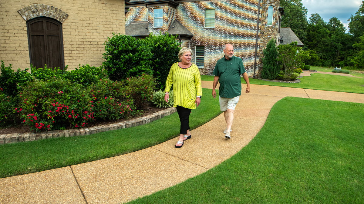 lawn care professional walks around with client for consult