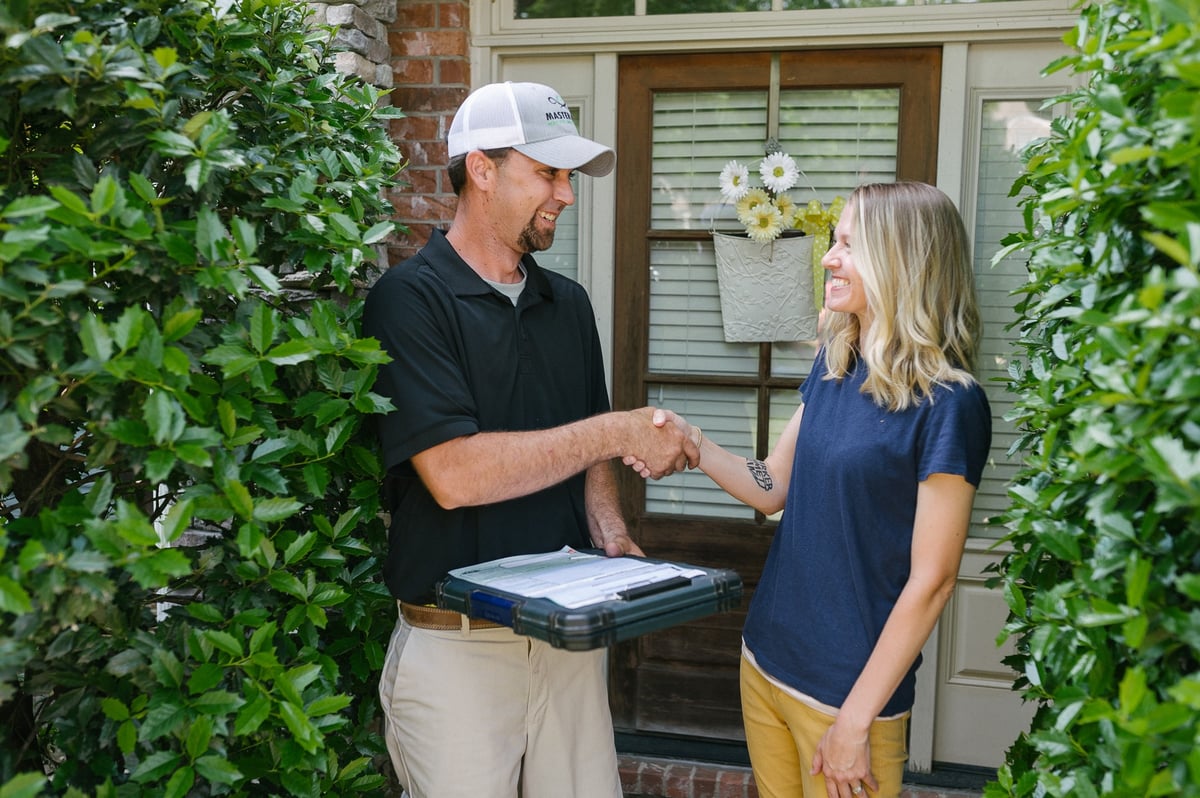 master lawn technician meets with customer