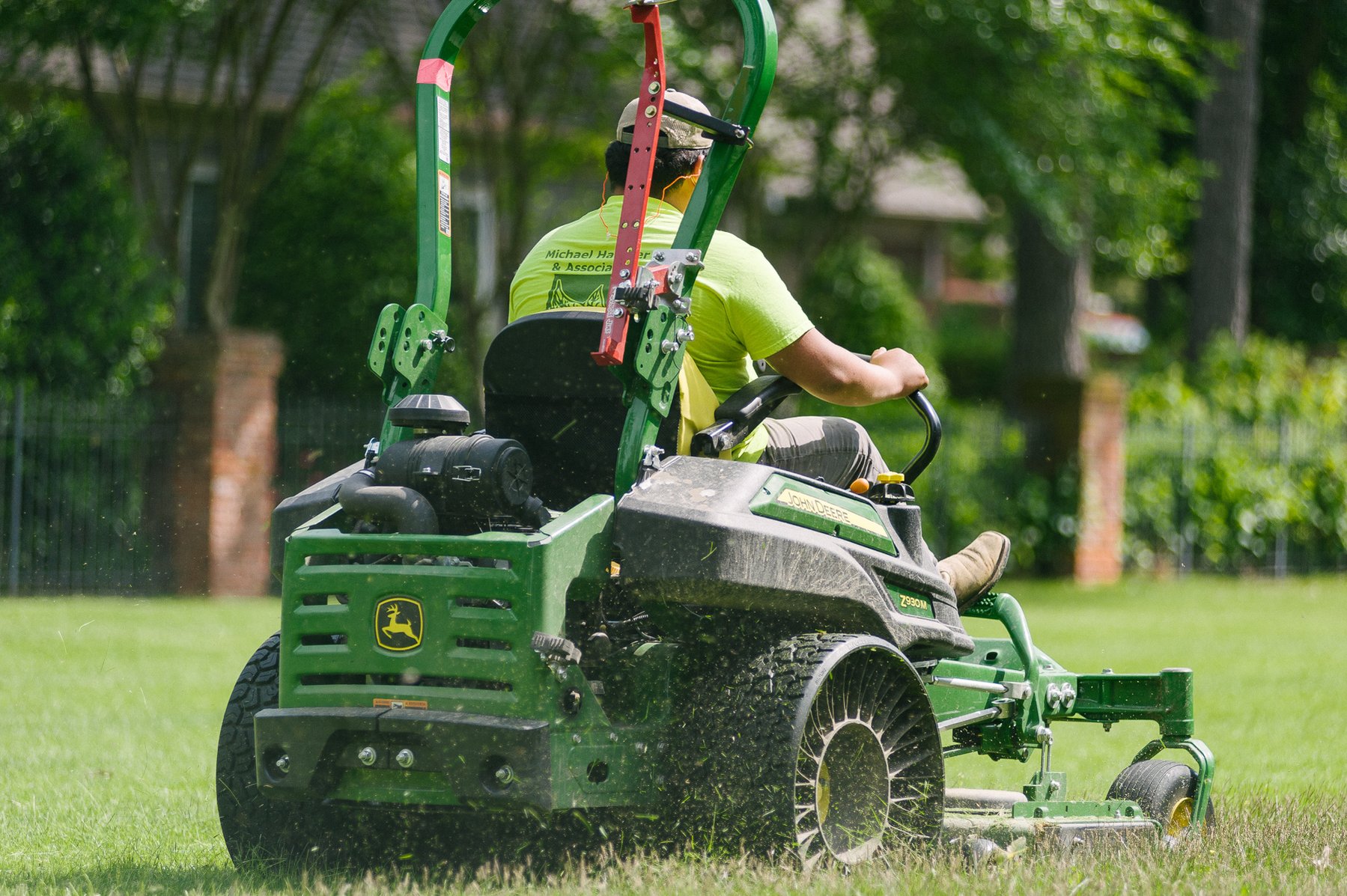 lawn care professional mowing lawn with ride on mower